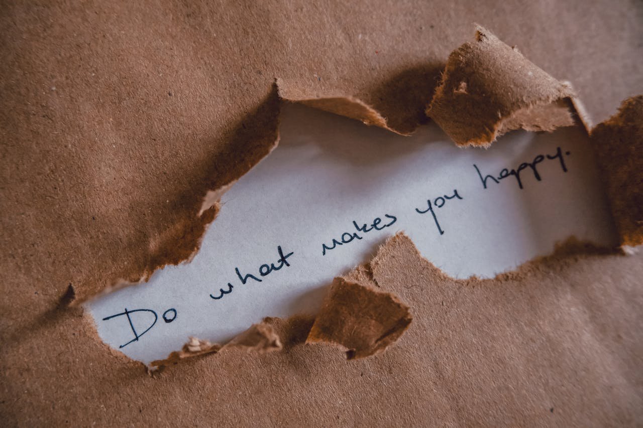 Brown paper revealing message Do what makes you happy.